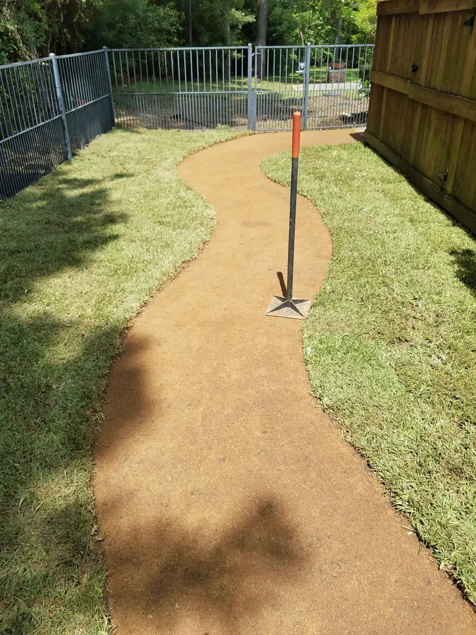 Maintained residential lawn and walkway with clean edges and organized planting beds