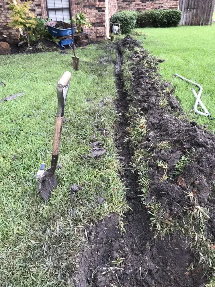 Residential yard opened for targeted grading, excavation, and drainage preparation