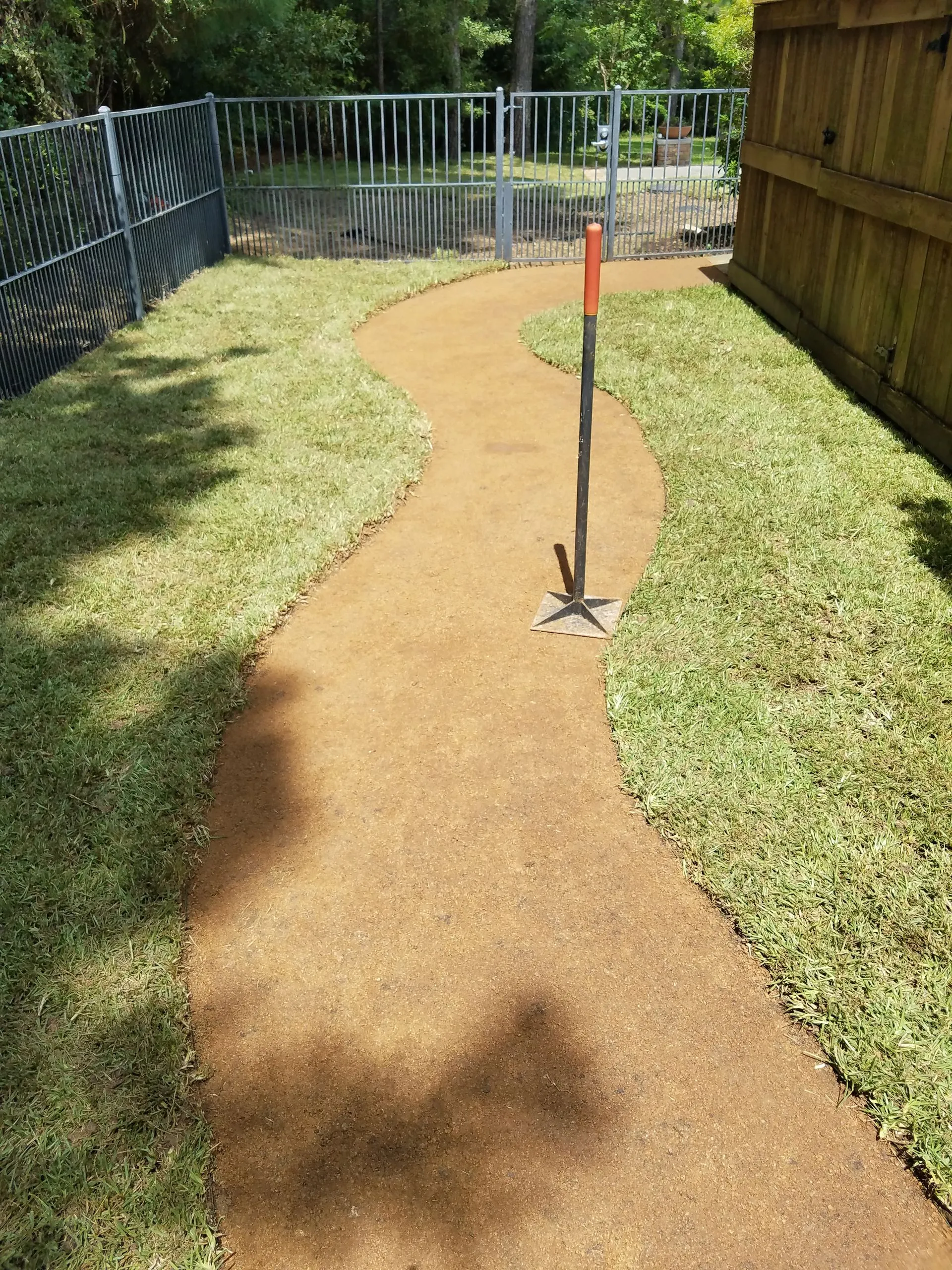 Finished curved walkway through a residential lawn